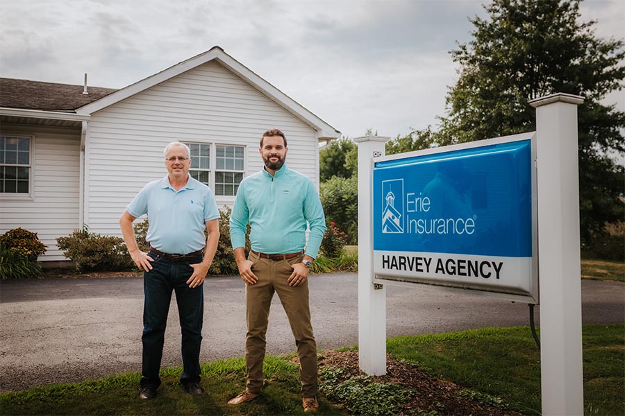 HARVEY INSURANCE - Owners Standing Outside the Office in Benton, PA on a Nice Day by the Agency Sign